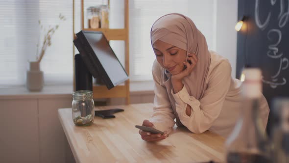 Muslim Woman Using Smartphone At Work