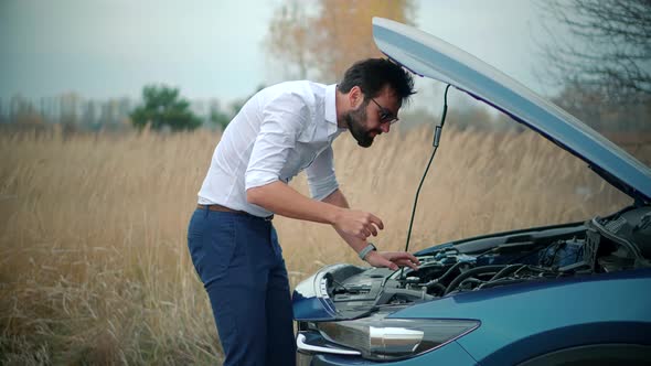 Businessman Repairing Accident Car. Man On Broken Car. Vehicle Check Engine Damage Troubles.