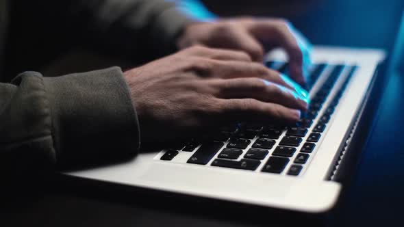 Extreme Closeup Hands of Unrecognizable Hacker Programmer Working Typing on Keyboard Laptop