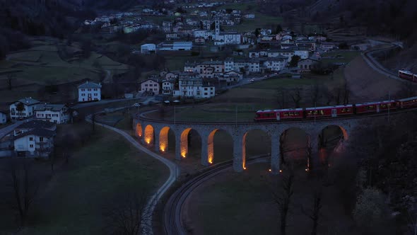 Train on Brusio Spiral Viaduct in Switzerland at Night