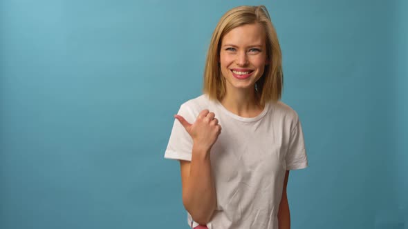 Beautiful Model Giving the Over There Sign While Smiling