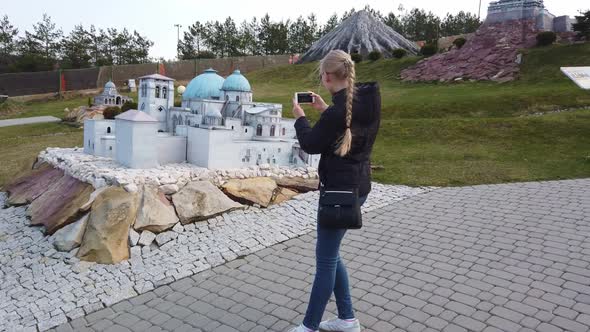 Woman Takes a Photo Near a Miniature Building in the Arabian Oriental Style. Park of Miniatures.