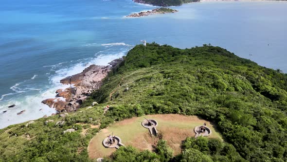 Aerial drone view of beach with ancient coastal artillery cannons attack fort in front of the ocean