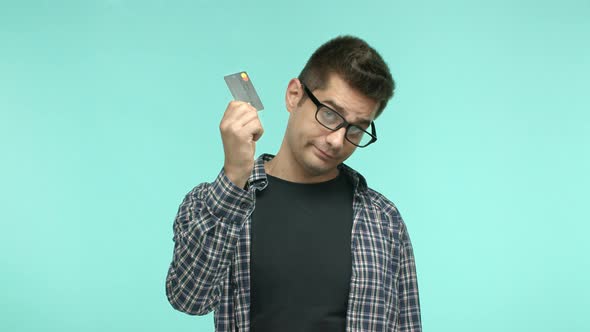 Adult Caucasian Man Showing Black Plastic Credit Card Asking for Contactless Payment Standing Over