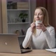 Portrait of a young caucasian woman sitting at the desk with laptop, typing an email, messaging - VideoHive Item for Sale