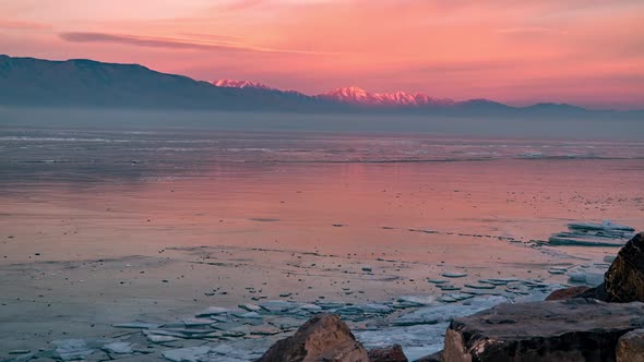 Looking over frozen Utah Lake as sky changes color during sunrise