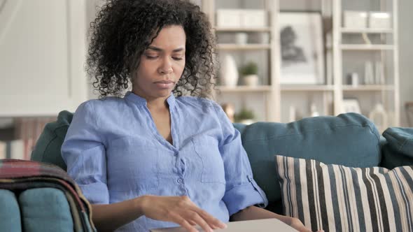 African Woman Leaving Room After Using Laptop