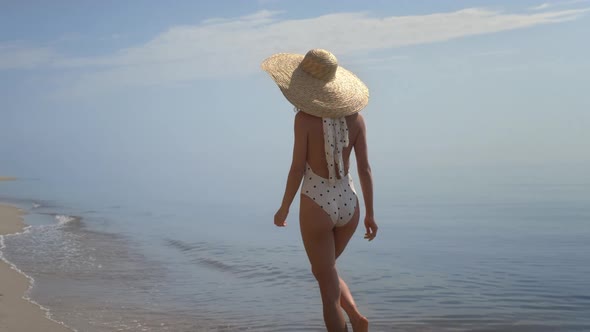 Seductive Girl Stepping Sea Waves Wearing Brimmed Hat
