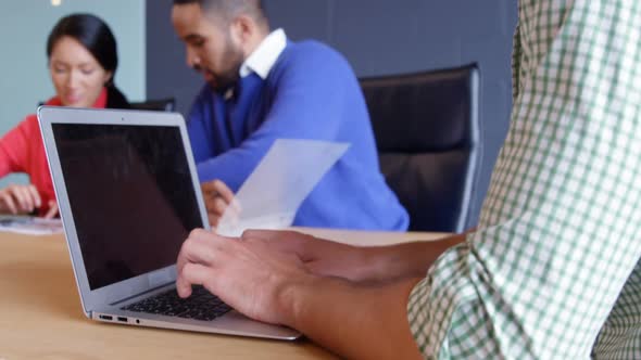 Male business executive using laptop