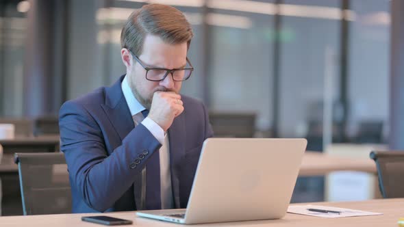 Businessman with Laptop having Coughing