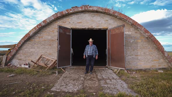 Desperate farmer near an empty barn.  World economic crisis