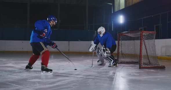 Professional Hockey Player Attacks the Gate and Strikes, but the Goalkeeper Beats the Puck. A Goal