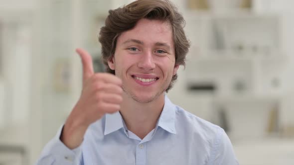 Portrait of Positive Young Businessman Doing Thumbs Up