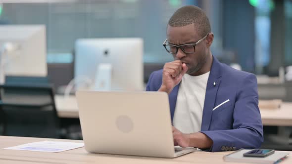 Young African Businessman with Laptop Having Coughing