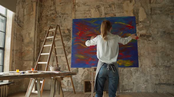 Female Artist Draws with Her Hands on the Large Canvas Creates Oil Painting