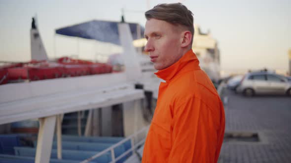 Smoking Worker of Logistics Company with Cigarette in Front of Vessels in Harbor During His Break