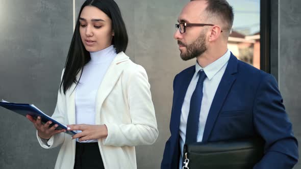 Colleague Discuss Business Hold Folder with Document Walking Together