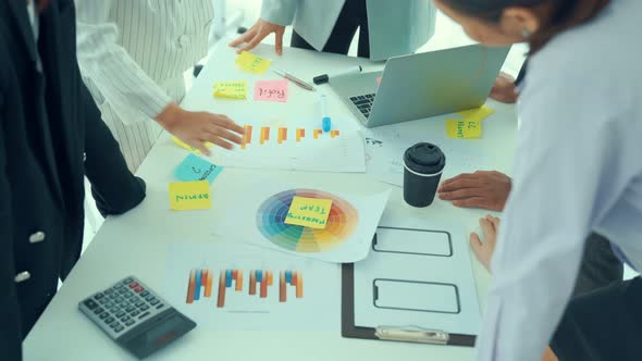 Business People Proficiently Discuss Work Project on Meeting Table