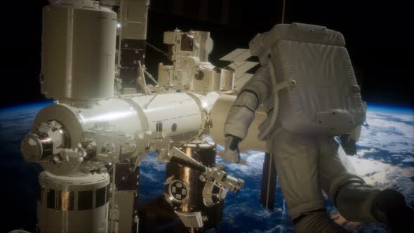 International Space Station and Astronaut in Outer Space Over the Planet Earth alt