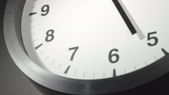 Clock Face In Time Lapse On Dark Grey Wall 