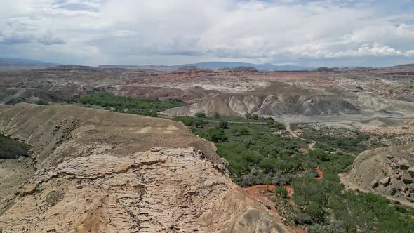 Flying over the desert and red Fremont River from summer monsoon storm