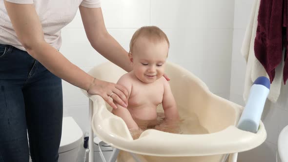 Happy Smiling Baby Boy Enjoying Having Bath