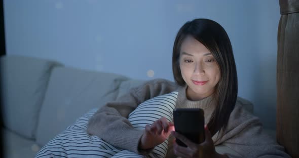 Woman check on smart phone at home in the evening