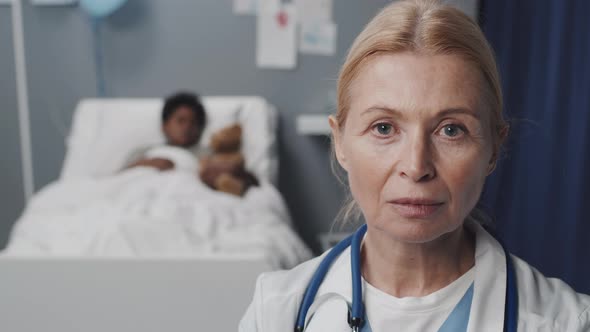 Blue-eyed Doctor Posing in Hospital Ward