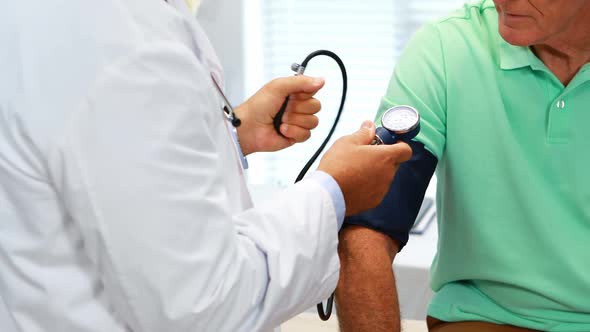 Doctor checking blood pressure of a patient