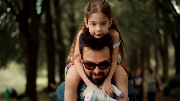 Father's Day. Kid Having Fun In Park. Carefree Dad With Preschool Daughter Enjoy Activity Together.