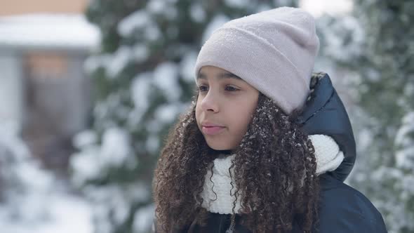 Coughing African American Teen Girl Spraying Throat Spray Standing Outdoors on Cold Winter Day