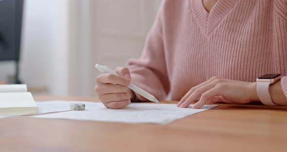 Woman write on the paper for study at home