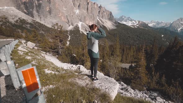 Slow Motion Shot of Happy Young Woman Walks in the Dolomites Mountains Northern Italy in the Summer