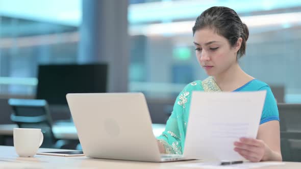 Indian Woman with Laptop Reading Documents
