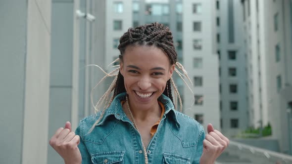 Darkskinned Young Girl with Dreadlocks Jumping for Joy Very Glad and Happy She Showing Yes Gratitude