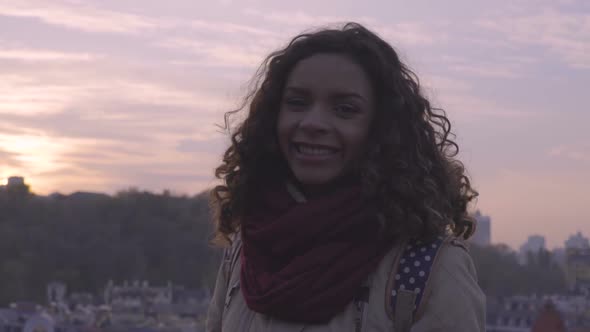 Beautiful Mixed-Race Woman Making Air Kiss, Posing for Camera With Smile on Face