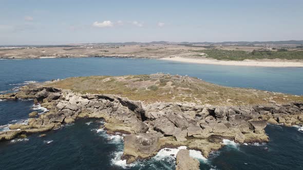 Aerial orbiting over old fortress ruins on Pessegueiro Island, Porto covo