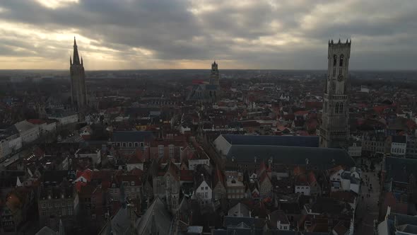 Aerial approach of three towers in Bruges' skyline