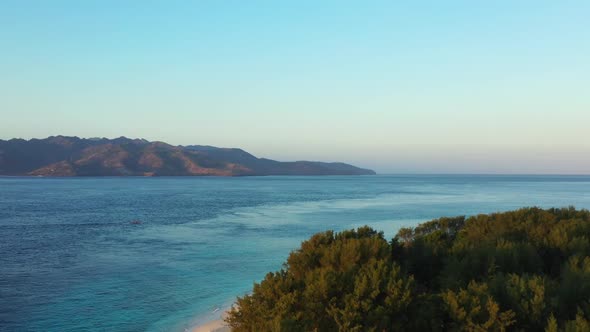 Aerial scenery of tranquil coastline beach adventure by blue water and white sandy background of a d