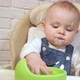 Baby Licks Her Mouth with Her Tongue Then Dips Her Fingers Into Cup of Food - VideoHive Item for Sale