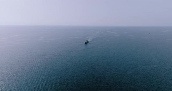 Aerial View of a Boat That Moves on the Deep Blue Sea