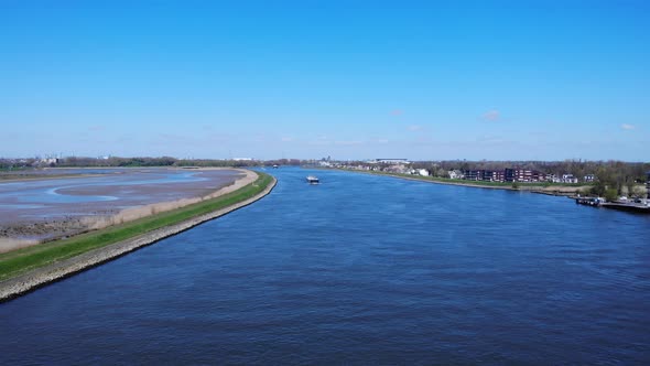 Freighter Ship Crossing At Noord River Passing By Natuureiland Sophiapolder In Hendrik-Ido-Ambacht,