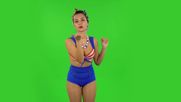 Beautiful Girl in a Swimsuit Is Blowing Kiss. Green Screen