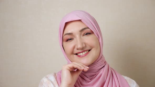 Muslim Woman Caucasian in Pink Headscarf Smiles Looking at Camera