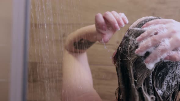 Beautiful Naked Young Woman Washes Her Hair and Uses Shampoo While Taking a Shower in the Bathroom