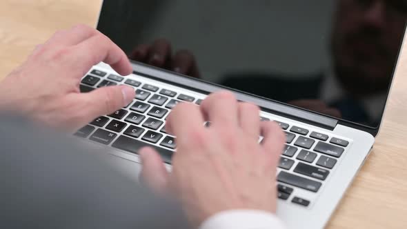 Businessman Typing on Laptop