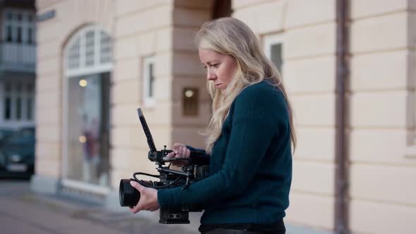 Female Film Maker Focusing Camera