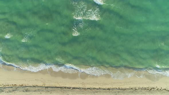 Ocean and Sandy Beach in Sunny Morning. Aerial Vertical Top-Down View