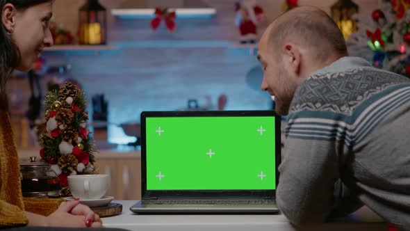 Couple Using Horizontal Green Screen on Christmas Eve