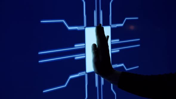 Human finger is pressing a digital button on a glowing touchscreen.